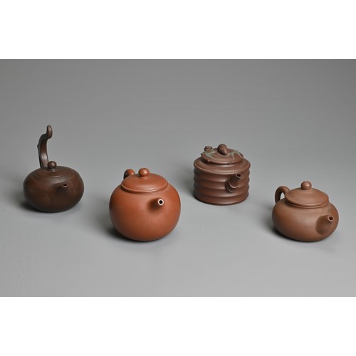 38 - FOUR CHINESE YIXING POTTERY TEAPOTS, 20TH CENTURY OR LATER. Of varying sizes and forms each with mak... 