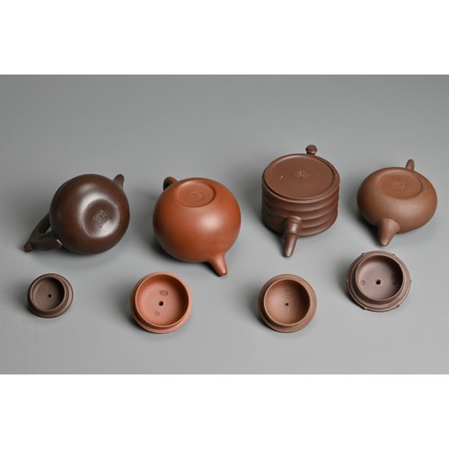 38 - FOUR CHINESE YIXING POTTERY TEAPOTS, 20TH CENTURY OR LATER. Of varying sizes and forms each with mak... 