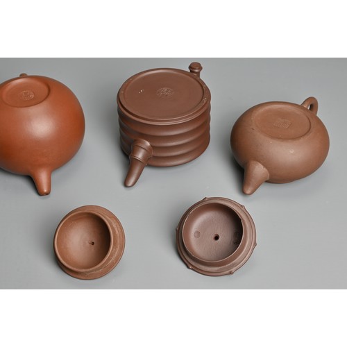 38 - FOUR CHINESE YIXING POTTERY TEAPOTS, 20TH CENTURY OR LATER. Of varying sizes and forms each with mak... 