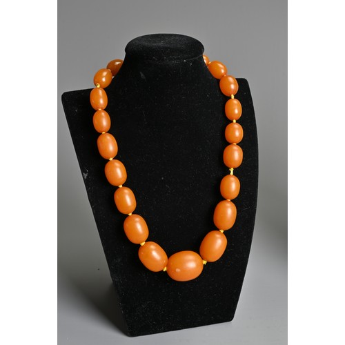 276 - AMBER BEADED NECKLACE, Oval beads of graduating sizes on a metal clasp, total weight 56 grams, appro... 