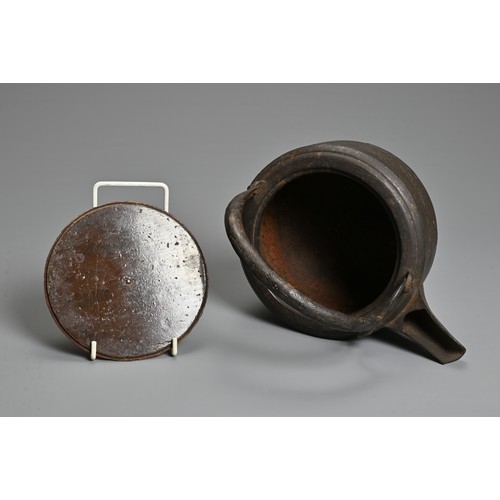 237 - A 20TH CENTURY JAPANESE CAST IRON CHOSHI (SAKE EWER), of squat form on tripod feet with black lacque... 