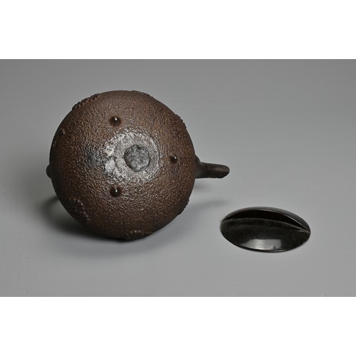 237 - A 20TH CENTURY JAPANESE CAST IRON CHOSHI (SAKE EWER), of squat form on tripod feet with black lacque... 