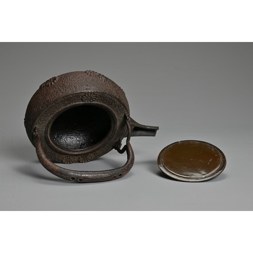 237 - A 20TH CENTURY JAPANESE CAST IRON CHOSHI (SAKE EWER), of squat form on tripod feet with black lacque... 