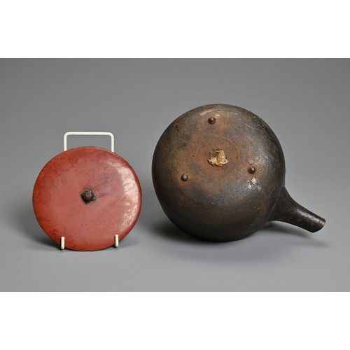 238 - A 20TH CENTURY JAPANESE CAST IRON CHOSHI (SAKE EWER), set on tripod feet with red lacquered wood cov... 