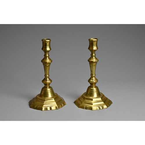 271 - A PAIR OF 19TH CENTURY BRASS BALUSTER CANDLESTICKS. Each with faceted nozzle and tapering column sup... 