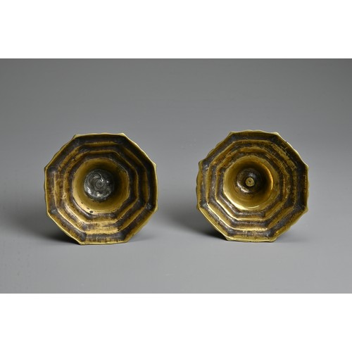 271 - A PAIR OF 19TH CENTURY BRASS BALUSTER CANDLESTICKS. Each with faceted nozzle and tapering column sup... 