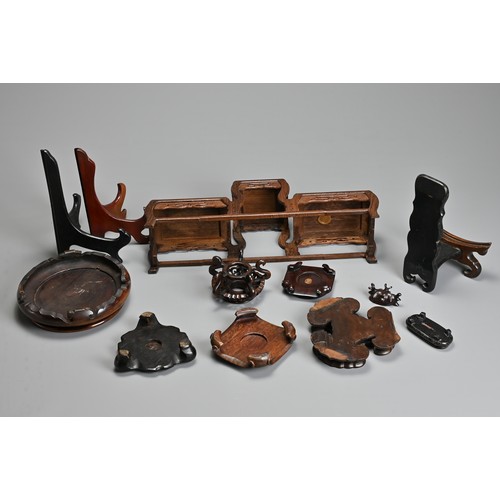 219 - A GROUP OF ASSORTED PLATE AND VASES STANDS, including carved hardwood CHINESE and Japanese examples,... 