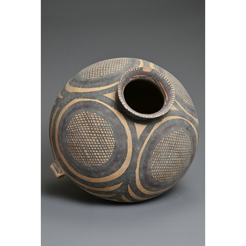 111 - A LARGE CHINESE NEOLITHIC MACHANG PAINTED POTTERY JAR. With two wide lug handles at the waist decora... 