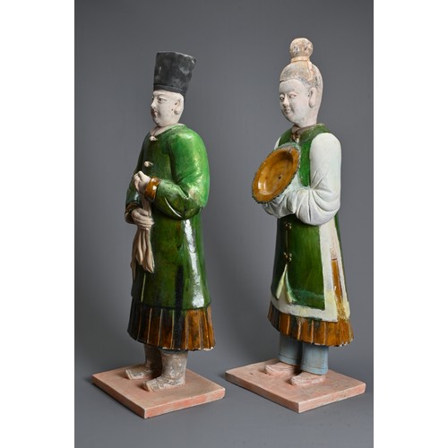 114 - A VERY LARGE PAIR OF CHINESE SANCAI GLAZED POTTERY FIGURES, MING DYNASTY OR LATER. Each figure heavi... 