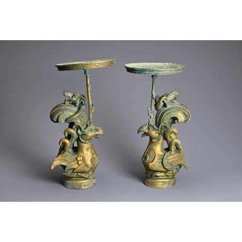 183 - A LARGE PAIR OF CHINESE ARCHAIC STYLE GILT BRONZE PHOENIX CANDLESTICKS. Elaborately cast in the form... 