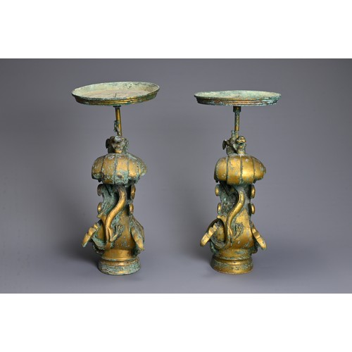 183 - A LARGE PAIR OF CHINESE ARCHAIC STYLE GILT BRONZE PHOENIX CANDLESTICKS. Elaborately cast in the form... 