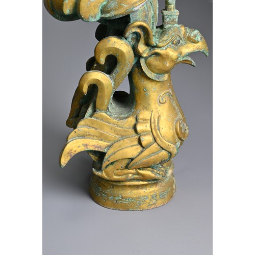 183 - A LARGE PAIR OF CHINESE ARCHAIC STYLE GILT BRONZE PHOENIX CANDLESTICKS. Elaborately cast in the form... 