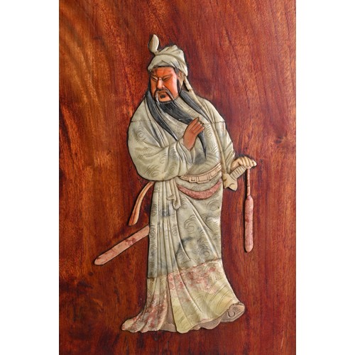 225 - A CHINESE HARDWOOD PANEL INLAID WITH SOAPSTONE FIGURE OF GUANDI, 19/20TH CENTURY. With metal wall mo... 