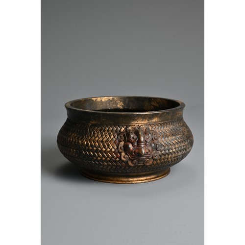 43 - A CHINESE GILT AND RED LACQUER BRONZE CENSER. Of squat form with a basket weave exterior and twin li... 