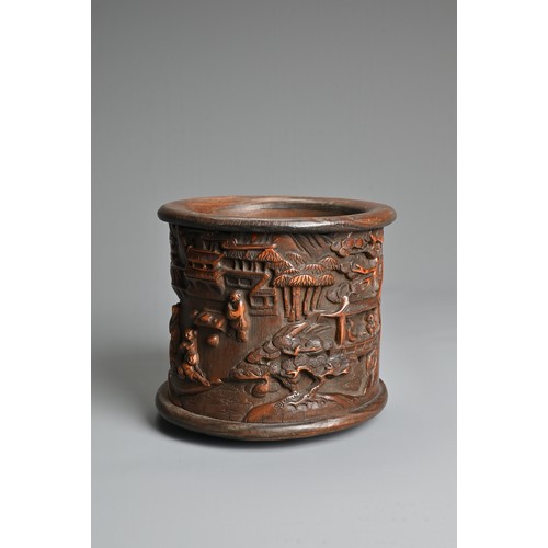 104 - A CHINESE BAMBOO BRUSH POT. Decorated in relief with figures in a courtyard scene inscribed near bas... 