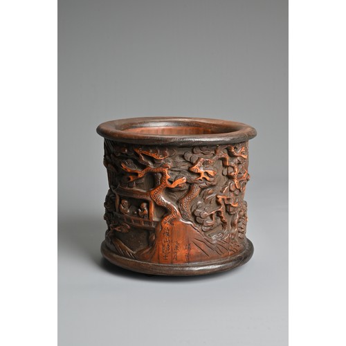 104 - A CHINESE BAMBOO BRUSH POT. Decorated in relief with figures in a courtyard scene inscribed near bas... 