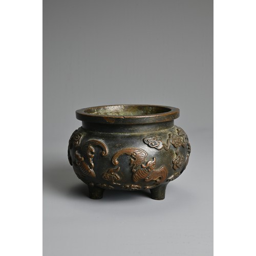 156 - A CHINESE BRONZE TRIPOD CENSER. Of squat globular form decorated in relief with bats and clouds. Apo... 