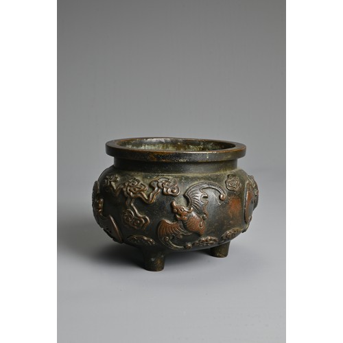 156 - A CHINESE BRONZE TRIPOD CENSER. Of squat globular form decorated in relief with bats and clouds. Apo... 