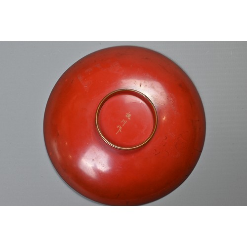 245 - A JAPANESE MEIJI PERIOD (1868-1912) RED LACQUER SAKE CUP. Of circular shallow form, decorated in gil... 