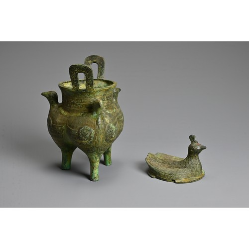 241 - A CHINESE ARCHAIC STYLE BRONZE TRIPOD VESSEL. Bird form finials to each leg with a bird form cover, ... 