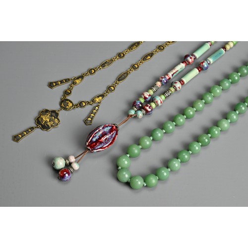 279 - THREE NECKLACES. To include a ceramic beaded necklace; A jade stone beaded necklace mounted with sil... 