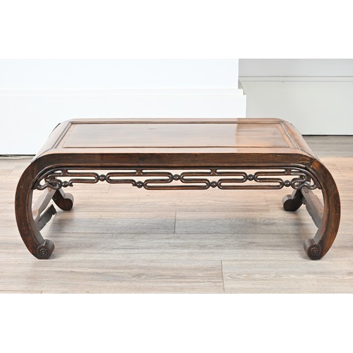 203 - AN EARLY 20TH CENTURY CHINESE CARVED HARDWOOD LOW TABLE. Scroll ended, with moulded top and pierced ... 