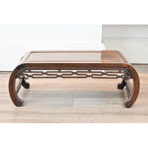 203 - AN EARLY 20TH CENTURY CHINESE CARVED HARDWOOD LOW TABLE. Scroll ended, with moulded top and pierced ... 