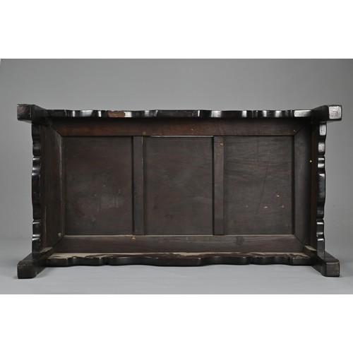 204 - A CHINESE HARDWOOD LOW RECTANGULAR TABLE, QING DYNASTY. The frieze carved with bats, ruyi clouds, dr... 