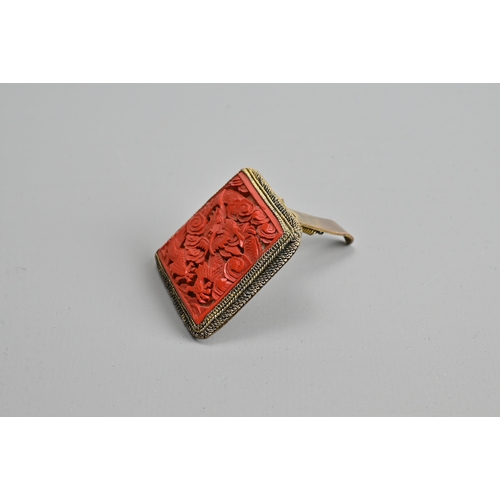 227 - A CHINESE RED LACQUER DRAGON BROOCH, EARLY 20TH CENTURY. Of square form featuring a dragon amidst cl... 