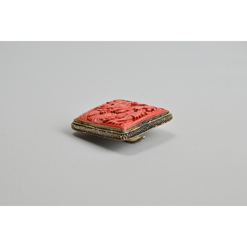 227 - A CHINESE RED LACQUER DRAGON BROOCH, EARLY 20TH CENTURY. Of square form featuring a dragon amidst cl... 