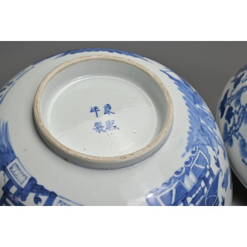 1 - A LARGE PAIR OF CHINESE BLUE AND WHITE PORCELAIN BOWLS, LATE 19TH CENTURY. Each decorated with build... 