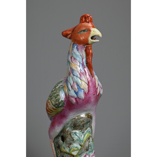 30 - A CHINESE FAMILLE ROSE PORCELAIN MODEL OF A PHOENIX. Modelled standing on a rockwork base with peony... 