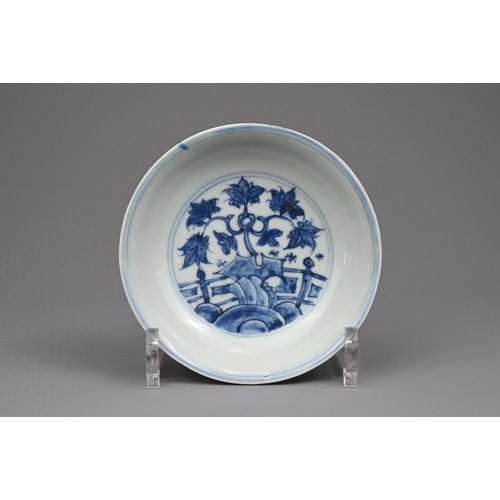 35 - A CHINESE BLUE AND WHITE PORCELAIN DISH, MING DYNASTY. Decorated with a twisted peach tree in garden... 