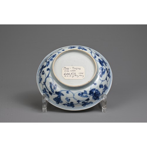 35 - A CHINESE BLUE AND WHITE PORCELAIN DISH, MING DYNASTY. Decorated with a twisted peach tree in garden... 