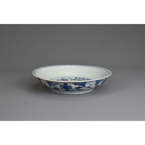 35 - A CHINESE BLUE AND WHITE PORCELAIN DISH, MING DYNASTY. Decorated with a twisted peach tree in garden... 