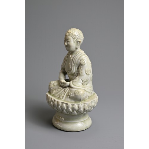 44 - AN UNUSUAL CHINESE PALE CELADON GLAZED PORCELAIN FIGURE OF BUDDHA, 17/18TH CENTURY. Seated on a rais... 