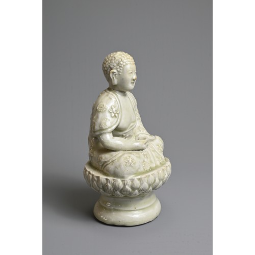 44 - AN UNUSUAL CHINESE PALE CELADON GLAZED PORCELAIN FIGURE OF BUDDHA, 17/18TH CENTURY. Seated on a rais... 