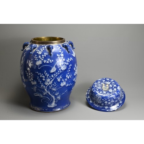 61 - A LARGE CHINESE BLUE AND WHITE PORCELAIN JAR AND COVERS, 19/20TH CENTURY. White enamel on a blue gro... 