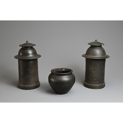 210 - THREE RARE CHINESE BURNISHED BLACK POTTERY JARS, YUAN DYNASTY (1279 – 1368). Comprising two tall cyl... 