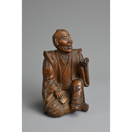 283 - A JAPANESE MEIJI PERIOD (1868-1912) CARVED WOOD OKIMONO OF AN SEATED ELDERLY GENTLEMAN. Modelled sea... 