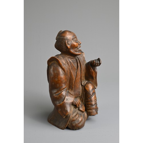 283 - A JAPANESE MEIJI PERIOD (1868-1912) CARVED WOOD OKIMONO OF AN SEATED ELDERLY GENTLEMAN. Modelled sea... 