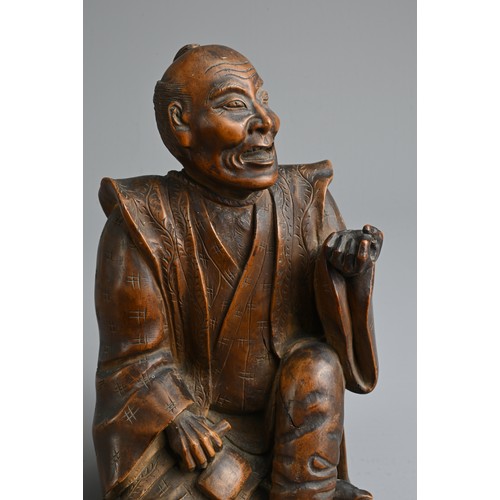 283 - A JAPANESE MEIJI PERIOD (1868-1912) CARVED WOOD OKIMONO OF AN SEATED ELDERLY GENTLEMAN. Modelled sea... 