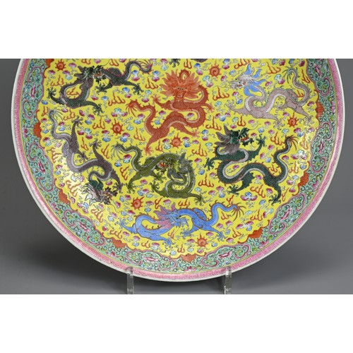 57 - A LARGE CHINESE FAMILLE ROSE ENAMELLED PORCELAIN DISH, EARLY 20TH CENTURY. Decorated to the interior... 