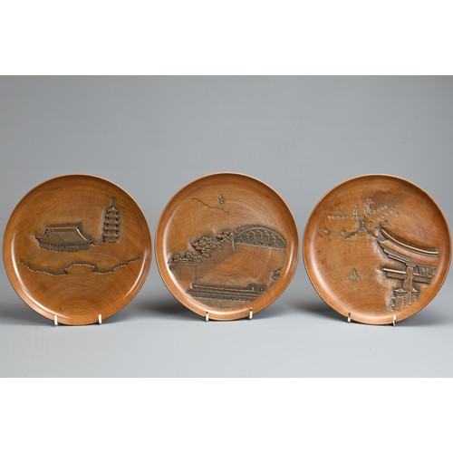 299 - FIVE 20TH CENTURY JAPANESE SENCHA (TEA CEREMONY) CARVED WOODEN CIRCULAR TRAYS. Each carved with a di... 