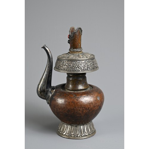 97 - A TIBETAN COPPER AND SILVER EWER, BUMPA, 19/20TH CENTURY. With copper body and splayed silver foot a... 