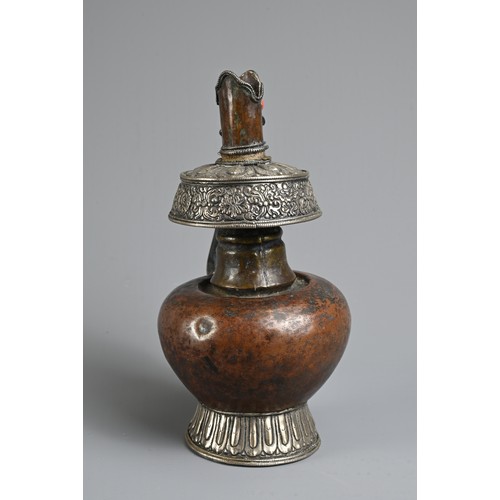 97 - A TIBETAN COPPER AND SILVER EWER, BUMPA, 19/20TH CENTURY. With copper body and splayed silver foot a... 