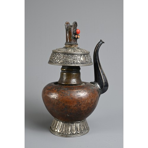 97 - A TIBETAN COPPER AND SILVER EWER, BUMPA, 19/20TH CENTURY. With copper body and splayed silver foot a... 