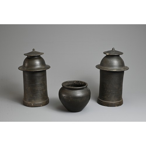 175 - THREE RARE CHINESE BURNISHED BLACK POTTERY JARS, YUAN DYNASTY (1279 – 1368). Comprising two tall cyl... 