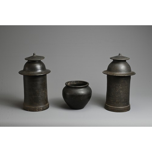 175 - THREE RARE CHINESE BURNISHED BLACK POTTERY JARS, YUAN DYNASTY (1279 – 1368). Comprising two tall cyl... 