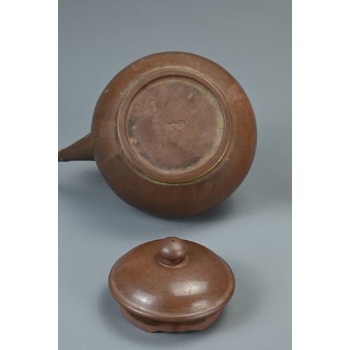 28 - TWO CHINESE YIXING POTTERY TEAPOTS, 19TH CENTURY AND LATER. The larger pot with bronze handle and tw... 